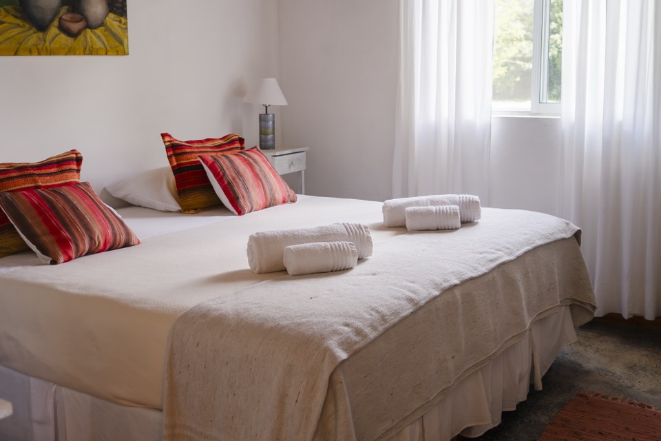 Bed with cushions and prepared towels