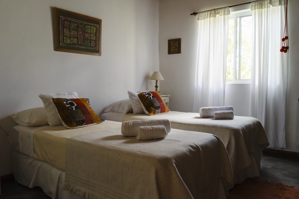 Twin beds with beige blanket