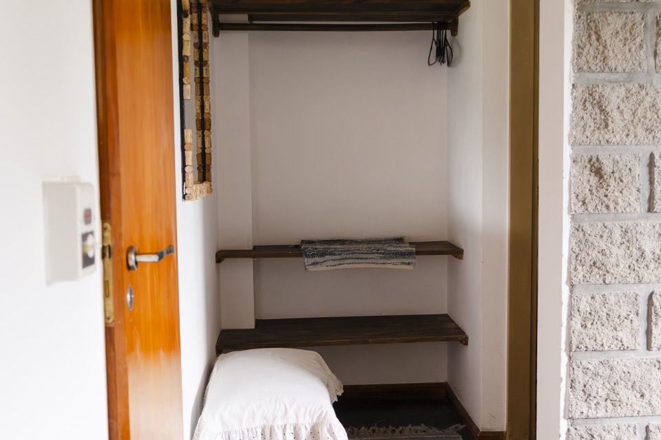Room wardrobe with towels and amenities